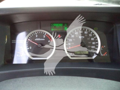 Isuzu NPR-HD dash cluster showing tachometer and speedometer with green warning display in center.