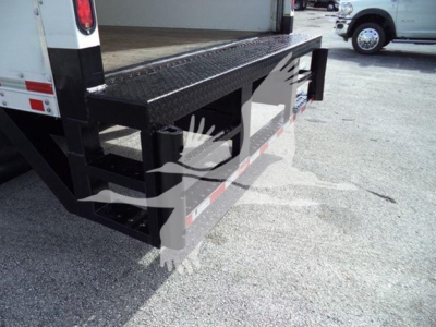 Isuzu NPR HD truck rear with black steel step and platform, side reflector, and tailgate edges visible.