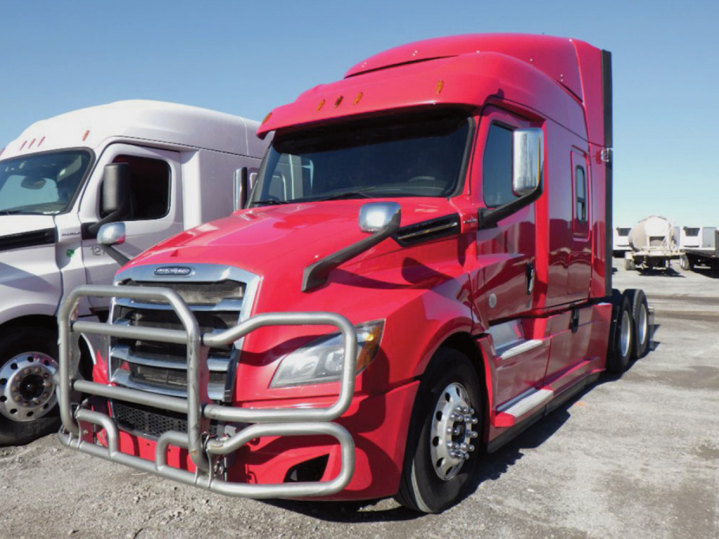 Freightliner Cascadia126 tractor cab in red with bull bar guard and side mirrors, front view on a lot.