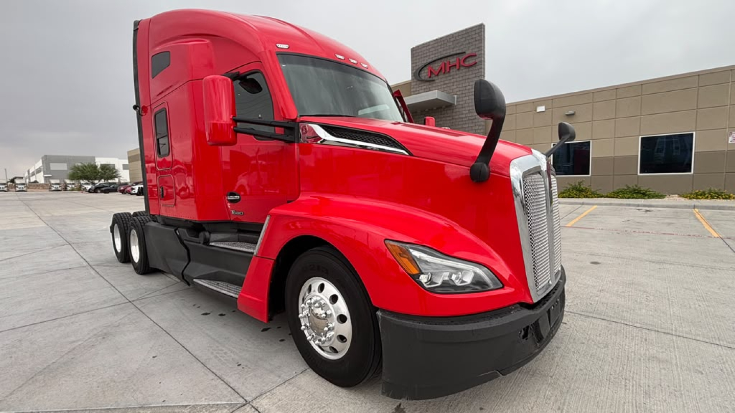 Kenworth T680 semi-truck in red with sleeper cab, front grille, and side mirrors. text visible includes Kenworth branding and truck features.