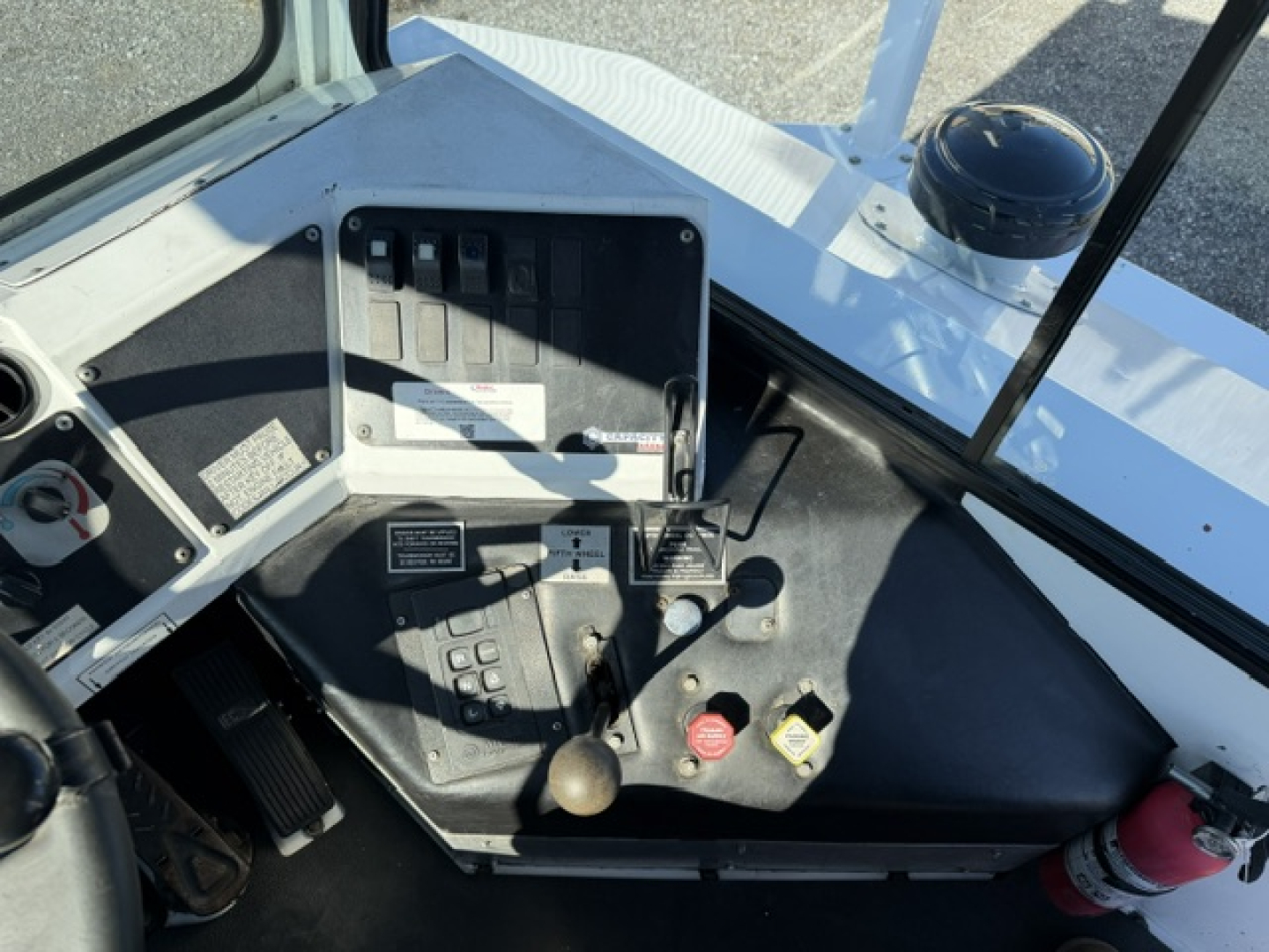 Operator cabin interior of a 2018 Capacity Sabre DOT truck showing dashboard levers, ignition, and control panels.