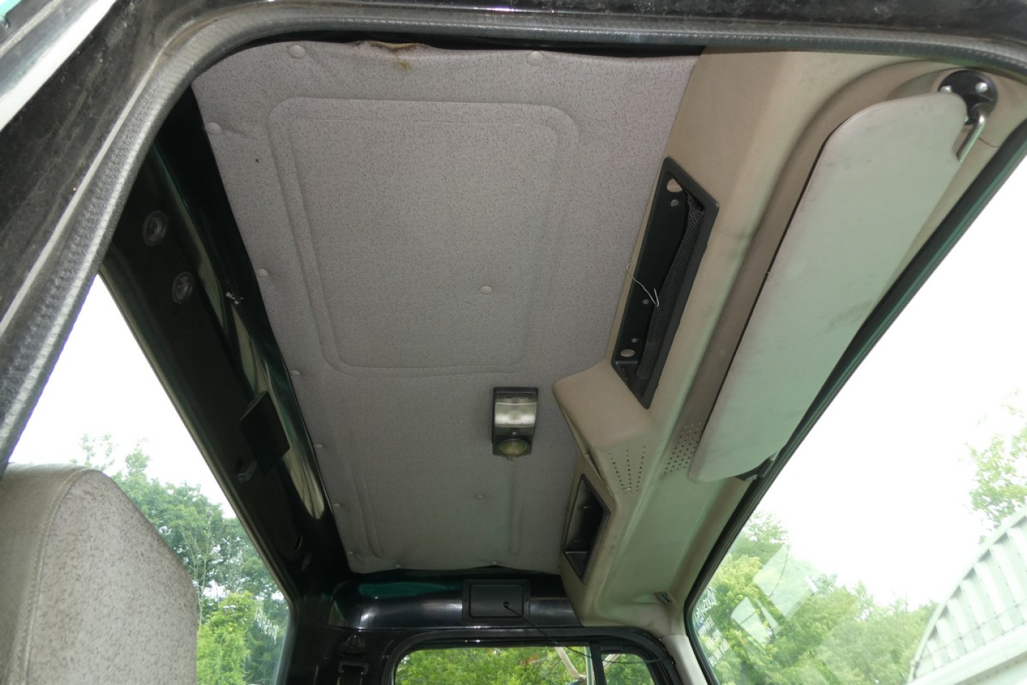 Interior cab ceiling view of a 1997 International 8100 showing overhead panel and headliner