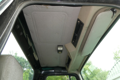 Interior cab ceiling view of a 1997 International 8100 showing overhead panel and headliner