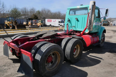 International 8100 truck cab and chassis showing dual rear axles and turquoise cab.