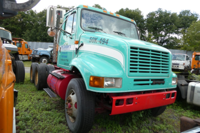 International 8100 conventionals truck in teal with red bumper and white accent, front view showing grille and windshield, stock number 0314251.