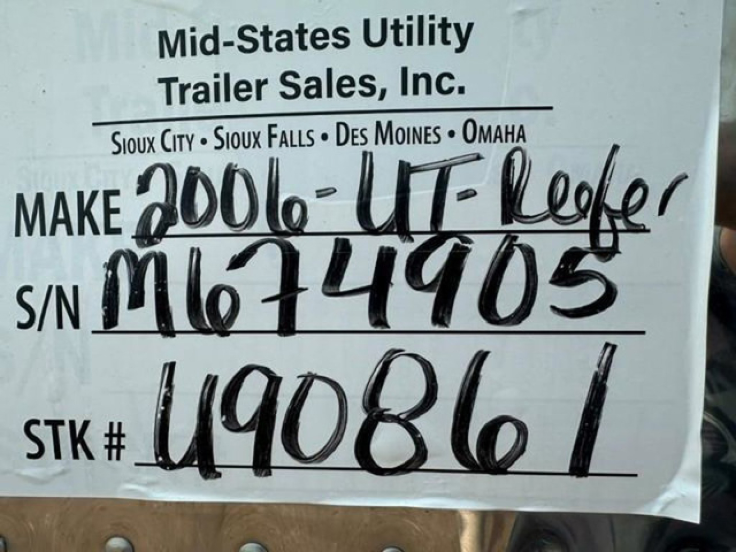 Trailer tag showing Mid-States Utility Trailer Sales, Inc. make 2006 UT- Reefer handwritten stock number M M674905 S/N U90861 on white label.