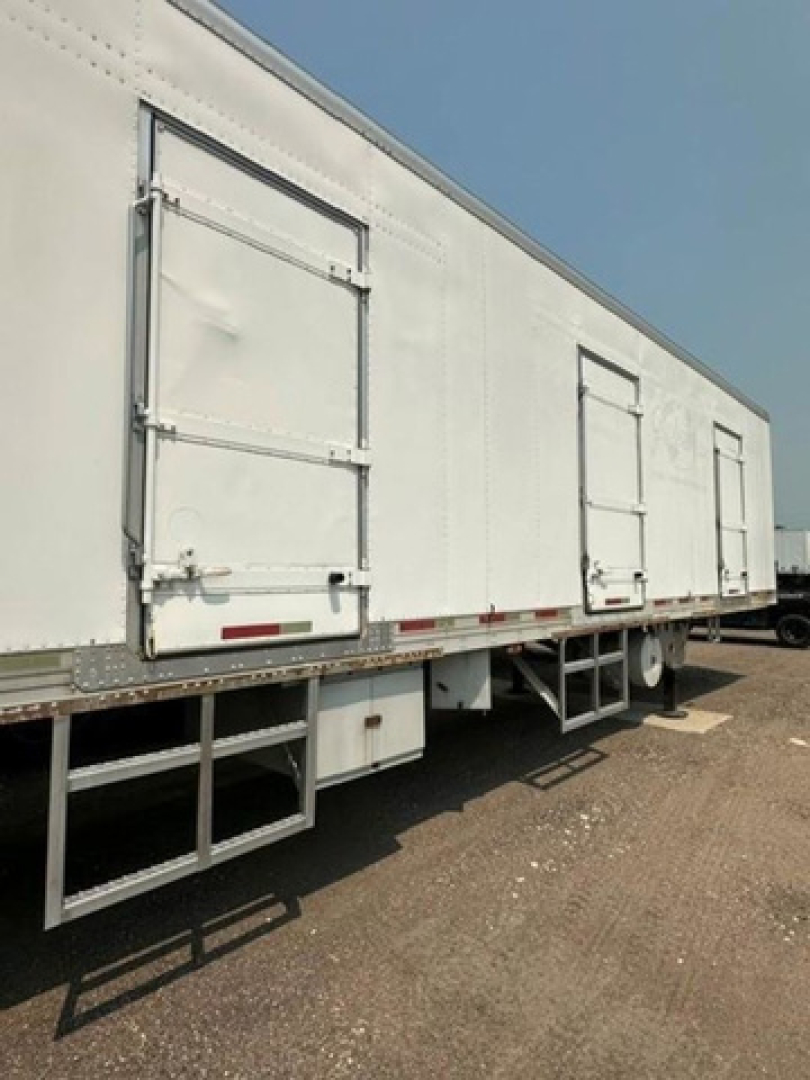 Refrigerated trailer side showing loading doors and access stairs for a 2006 utility reefer.