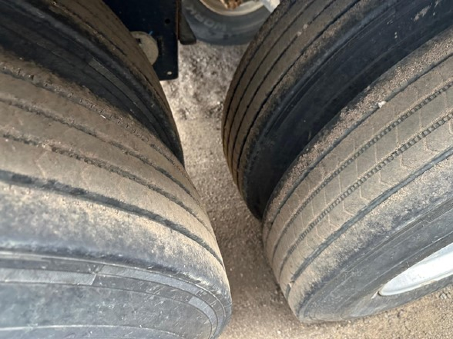 Dual rear trailer tires on a Timpte hopper, showing tread wear and wheel rims.