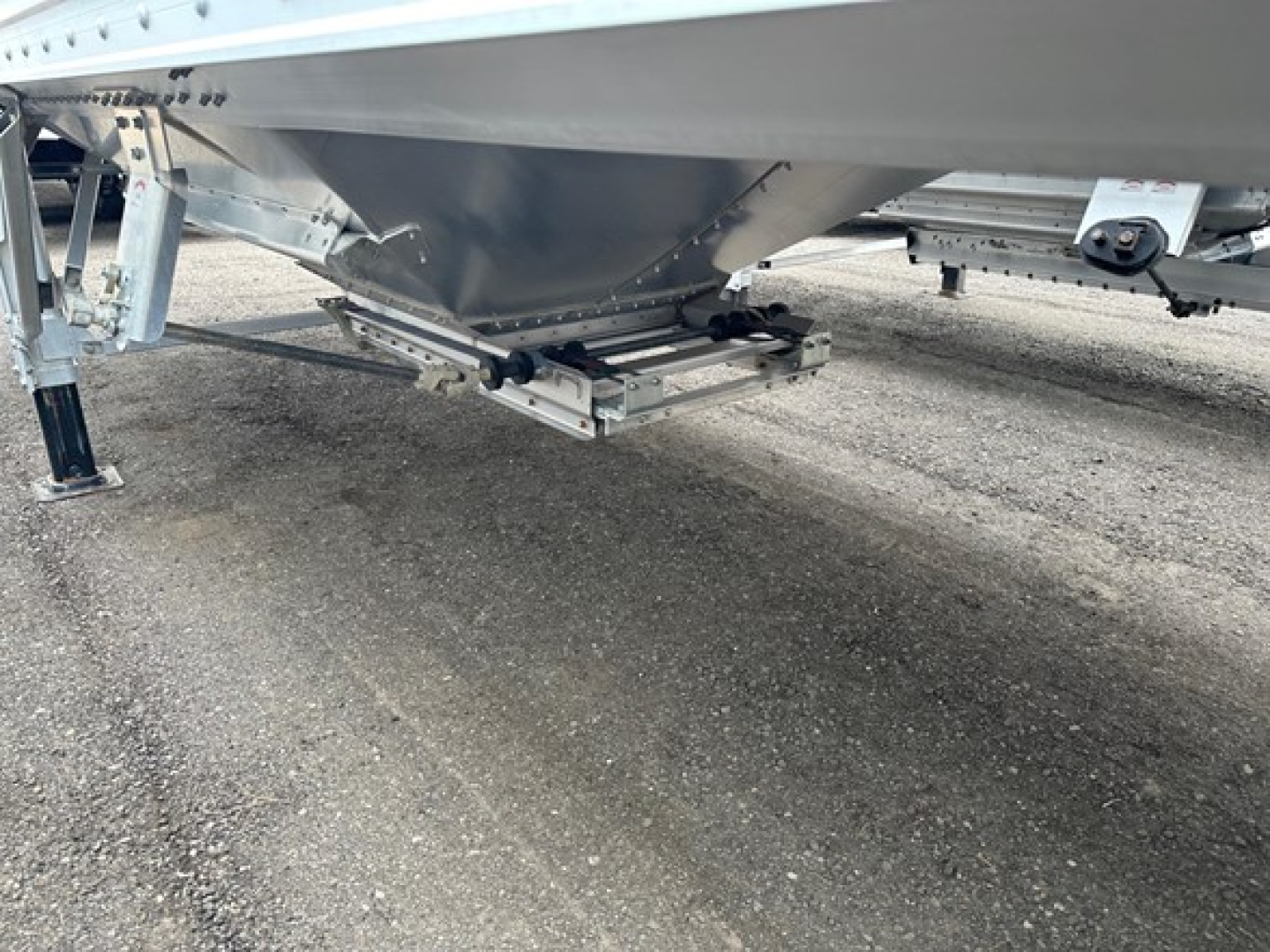 Hopper trailer undercarriage and hitch from side view, showing Timpte Super Hopper features and trailer support structures.