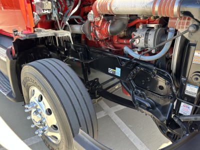 Kenworth T680 front chassis and engine bay showing suspension, twin I-beam frame, and front axle with Bridgestone tire.
