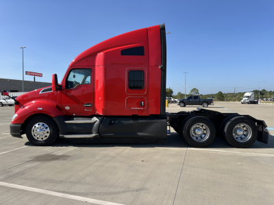 Kenworth T680 tractor side view showing red sleeper cab and rear wheels.