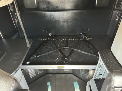 Kenworth T680 bed area showing interior cargo space with LATCH straps and floor anchor points.