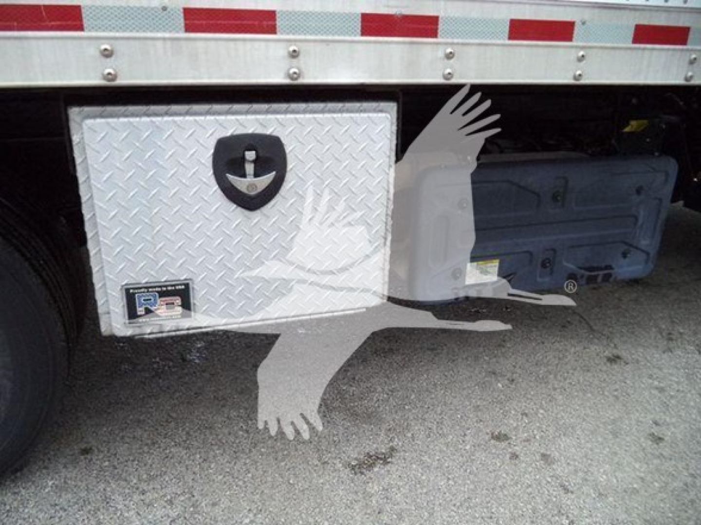 Isuzu NQR truck rear showing aluminum toolbox with diamond plate and under-bed storage box.
