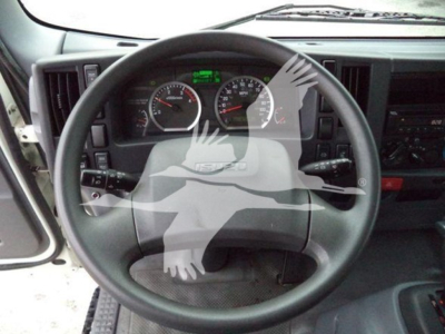 Isuzu NQR dashboard and steering wheel view showing gauge cluster and steering column.
