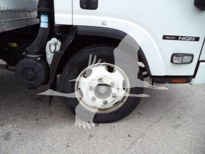 Isuzu NPR truck front wheel well and side step with Isuzu NQR badge visible.