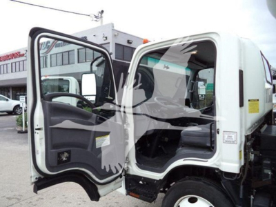Isuzu NQR truck cab with both doors open, interior view visible. VIN and stock number text not legible on image. No explicit fluid labels visible.