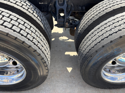 Dual rear tires of a Peterbilt 389 truck chassis showing inner chassis area between axles and wheel rims.