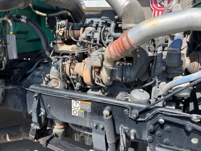 Peterbilt 389 engine bay showing intake manifolds and turbocharger with hoses and wiring visible.