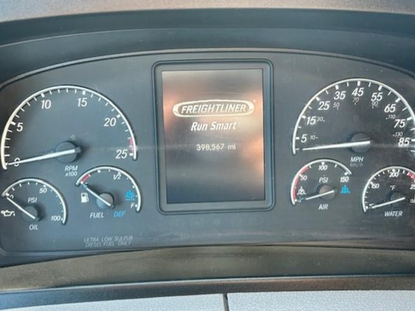 Dashboard of a 2022 Freightliner Cascadia 116 showing center display with Freightliner Run Smart and mileage 398,567 mi, surrounded by speedometer and gauges.