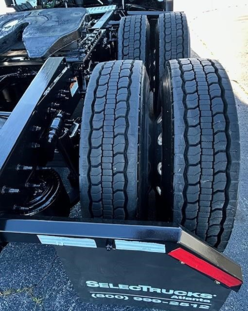 Freightliner Cascadia 116 rear view showing dual rear axles and tires, chassis components visible.
