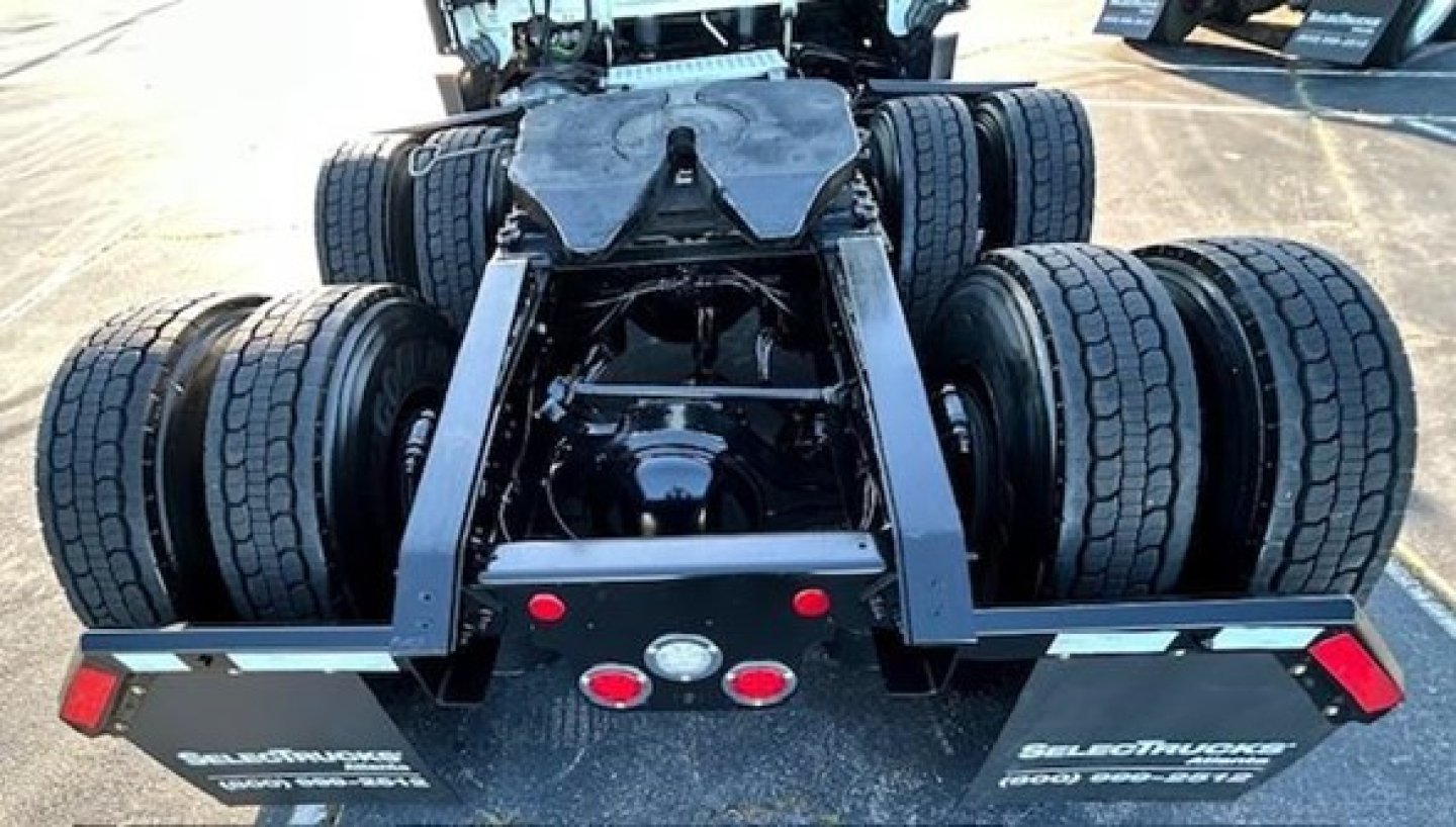Freightliner Cascadia 116 tractor rear view showing dual rear axles and fifth wheel hitch with tires visible.