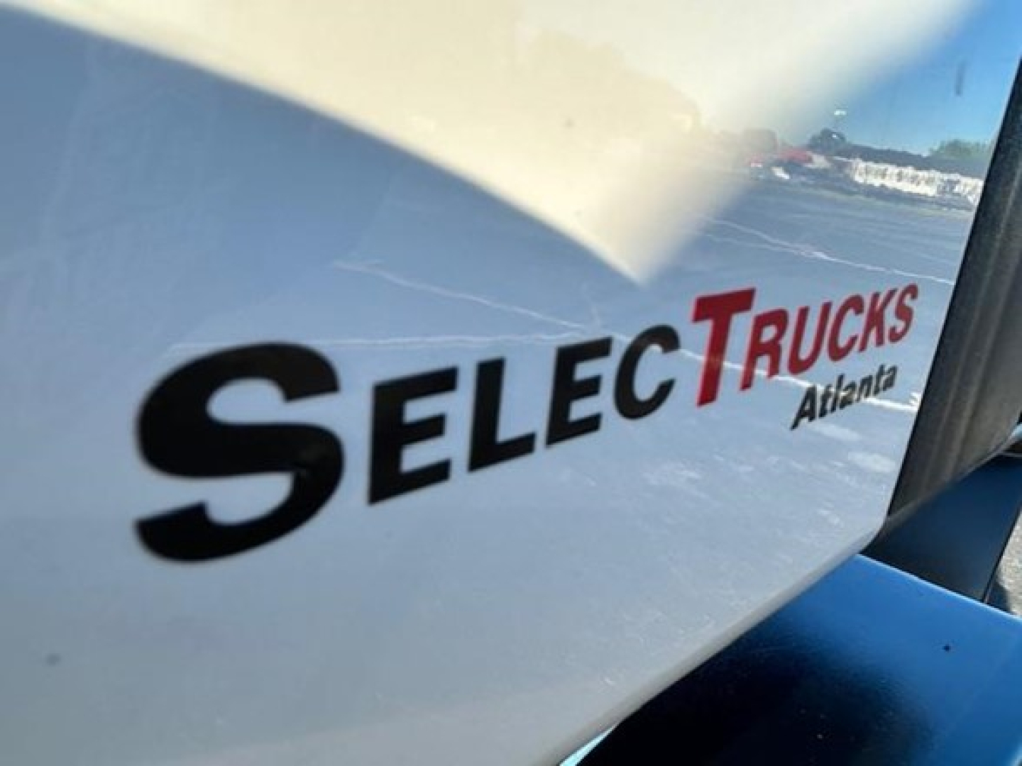 Truck cab side showing SelecTrucks Advantage logo on white surface