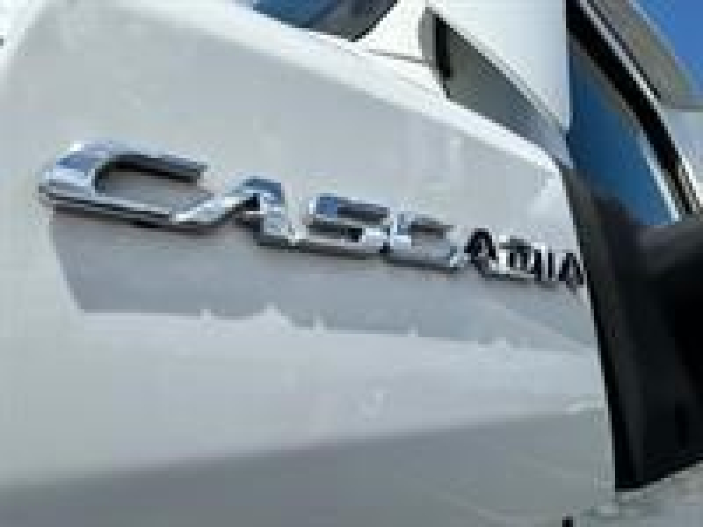 Freightliner Cascadia badge on truck rear door viewed from side.