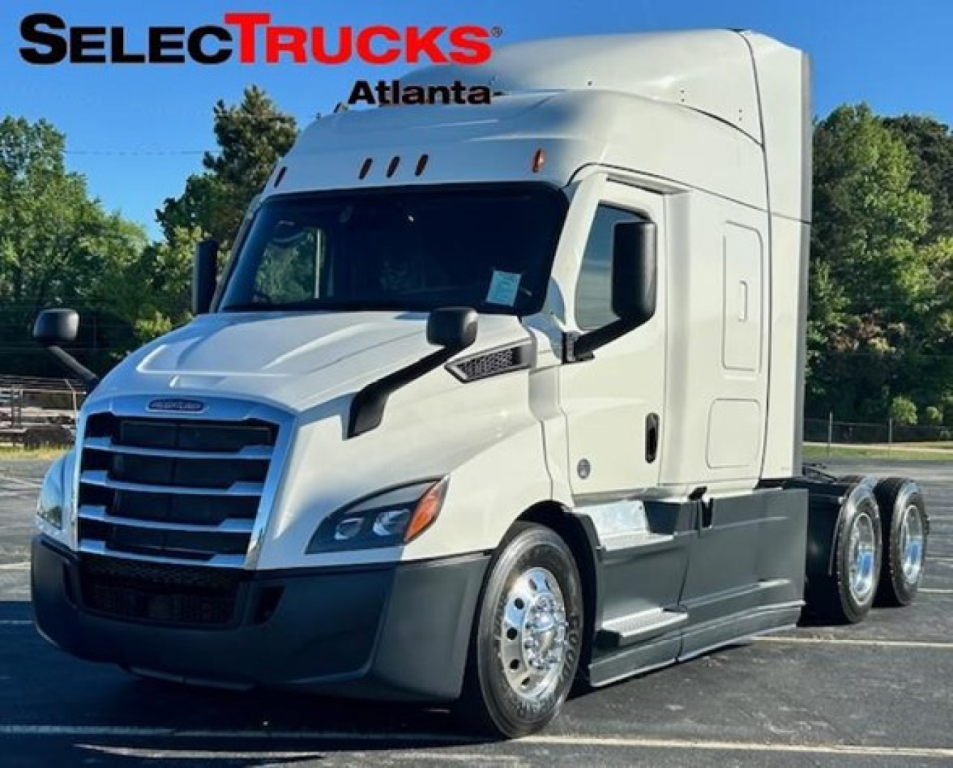 Freightliner Cascadia 116 truck in white with SelecTrucks Atlanta logo, side view showing cab and dual rear axles.