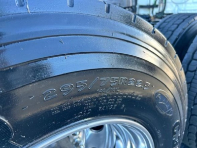 Tire sidewall with size 295/75R22.5 visible on Freightliner Cascadia 116 wheel
