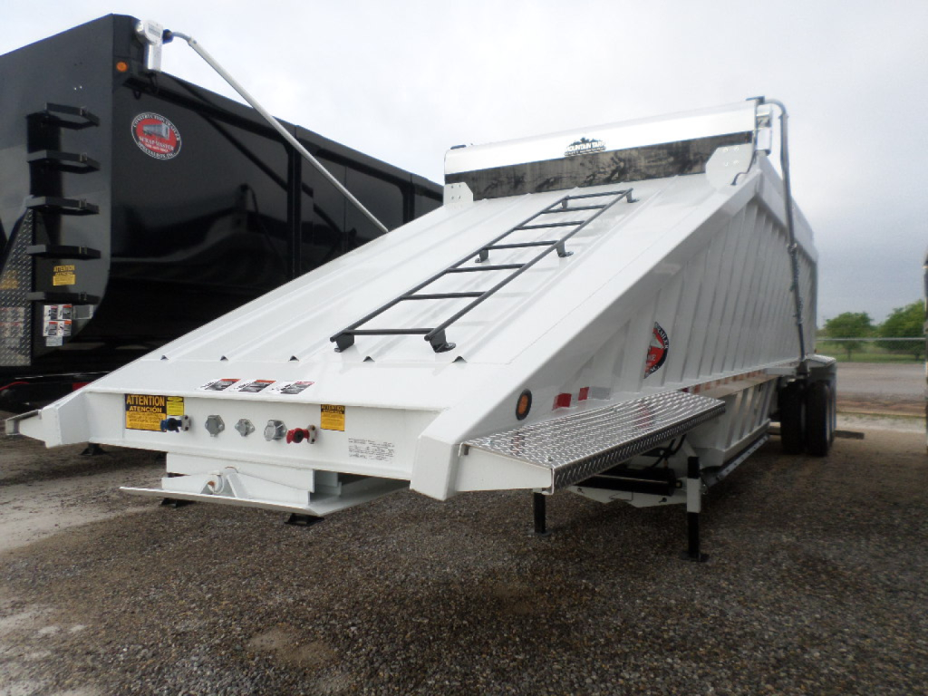 Trailer in service position showing dump bed and side step with ladder rungs and rear lights.