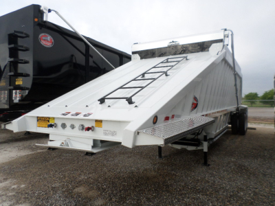 Trailer in service position showing dump bed and side step with ladder rungs and rear lights.