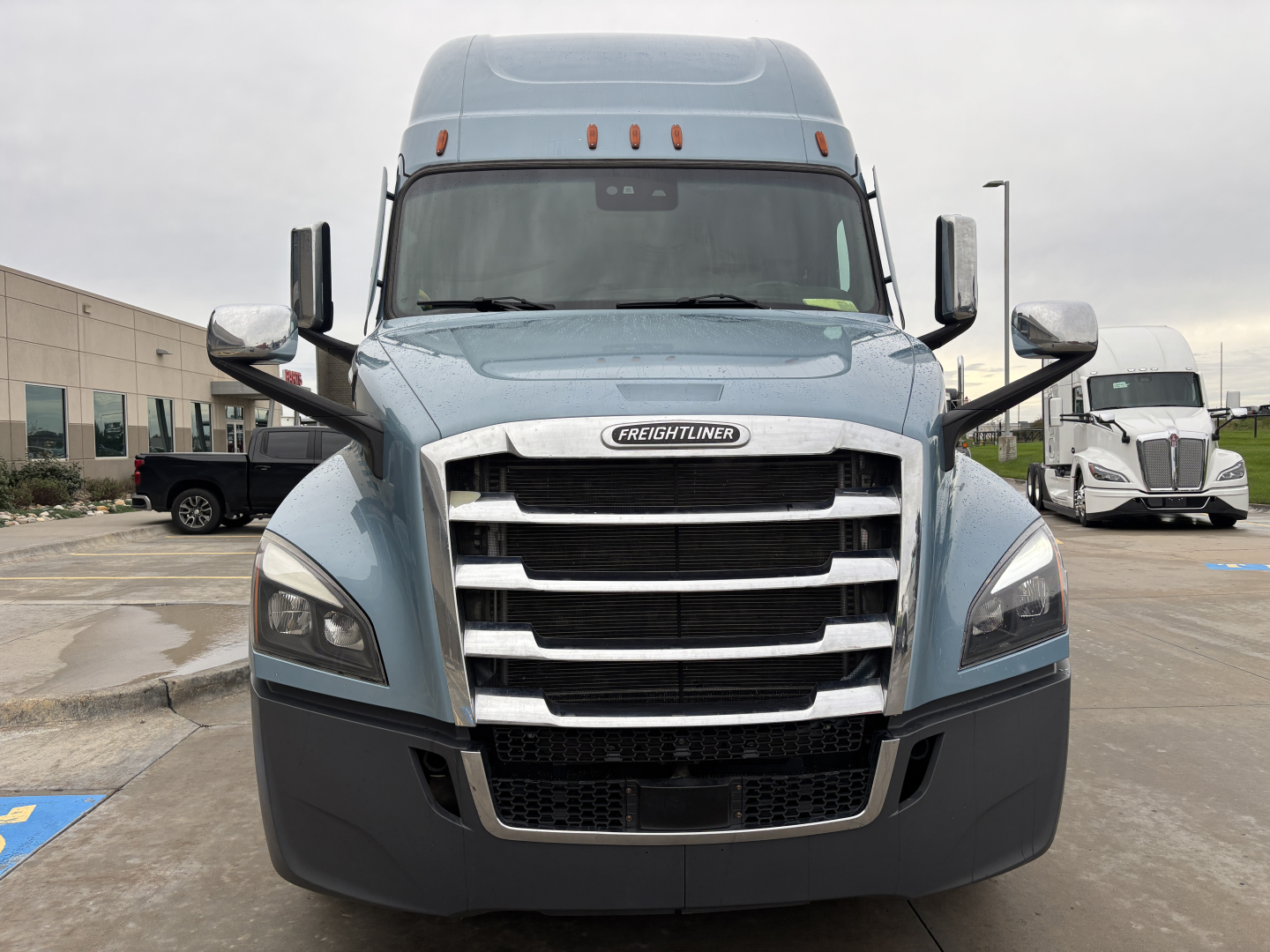 Freightliner PT126064ST front view showing grille and headlights with large chrome bumper and side mirrors.