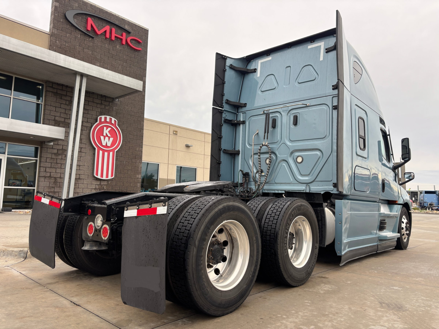 2023 Freightliner PT126064ST tractor rear view showing dual rear axles and sleeper cab with KW filter logo in background.