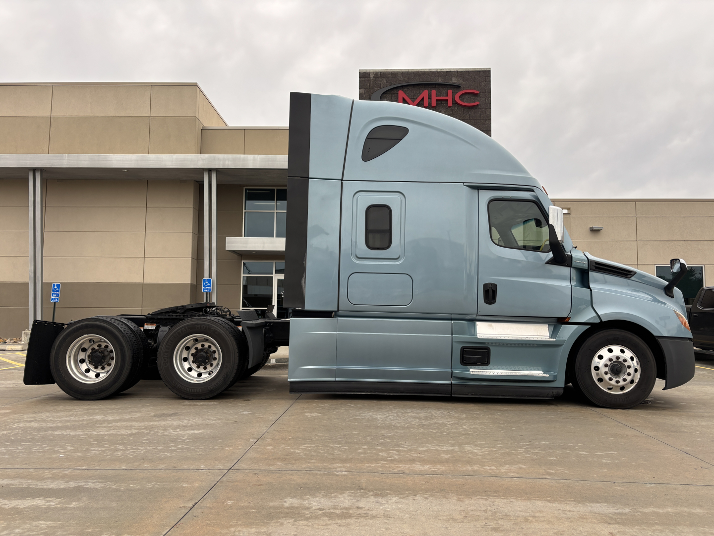 Freightliner PT126064ST tractor, side view showing cab with sleeper, dual rear axles, light blue paint, VIN 3AKJHHDR7PSNK5969 on listing.