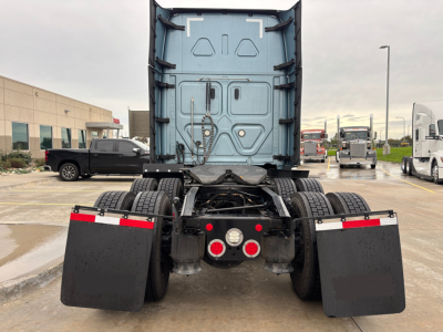Freightliner PT126064ST rear view showing fifth-wheel area, mud flaps, and dual rear axles on a used tractor truck.