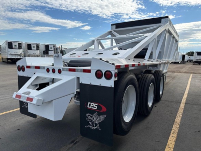 Bottom dump trailer showing white framework and triple-axle rear, CPS logo on mudflap, reflective tape along sides, and a rear bumper with a dump mechanism.