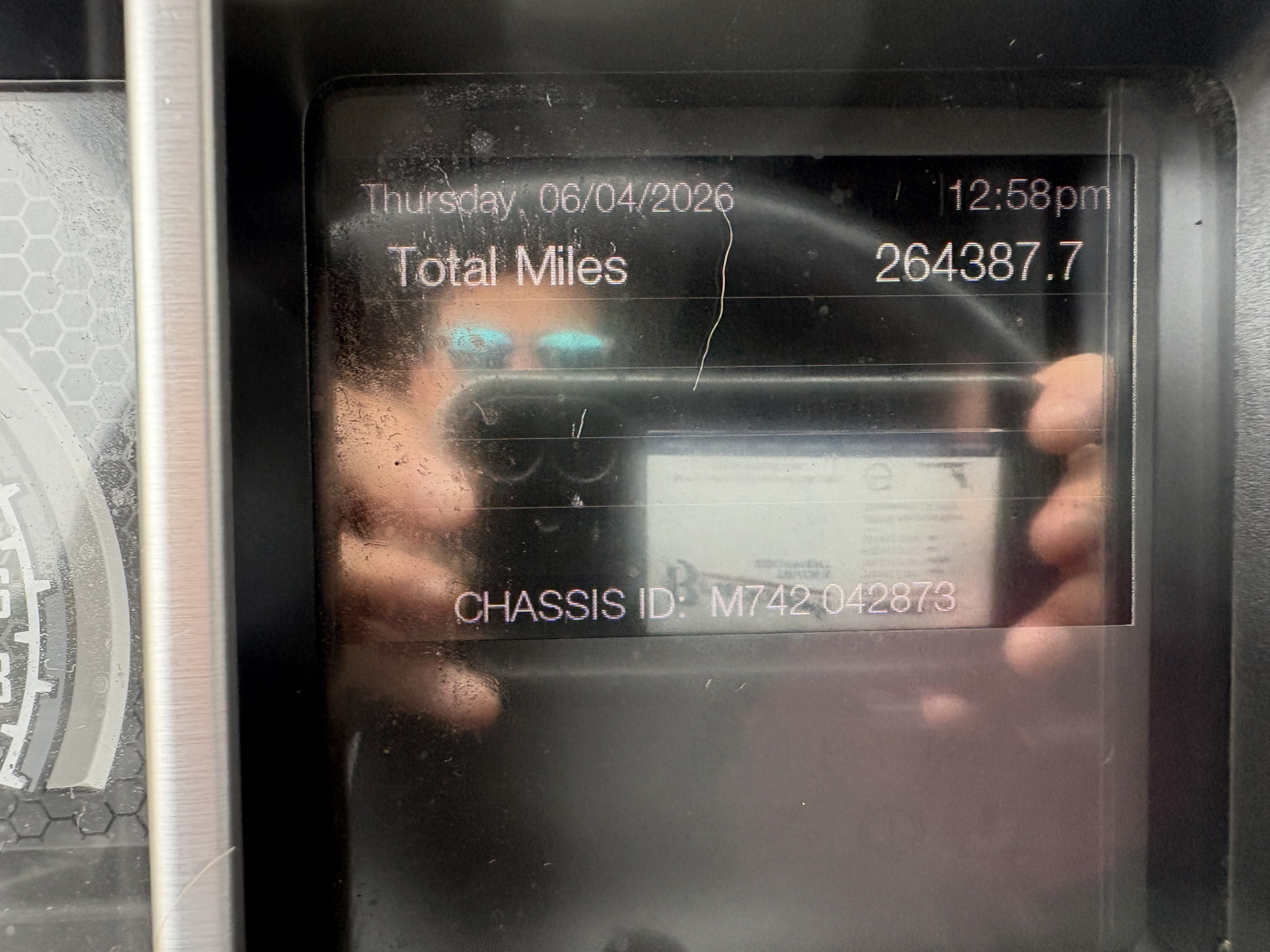 Cab interior display showing total miles 264387.7, date Thursday 06/04/2026, chassis ID M742042873 on Mack AN64T70 truck.