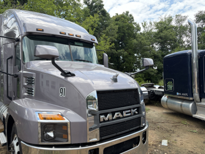 Mack AN64T70 conventional sleeper truck cab showing grille with MAC K logo and number 91 on door and side mirrors.
