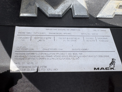 Mack AN64T70 engine data plate with lines of text including engine family, model MP8-XS? and serial number, fuel system, exhaust, and other specs. Visible: IMPORTANT ENGINE INFORMATION, ENGINE FAMILY PPWT? BEP1, ENGINE MODEL MP8-4? Serial N