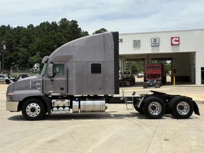 Mack AN64T70 conventional sleeper truck tractor side view showing fuel tanks and rear axles.