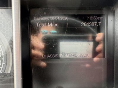 Cab interior display showing total miles 264387.7, date Thursday 06/04/2026, chassis ID M742042873 on Mack AN64T70 truck.