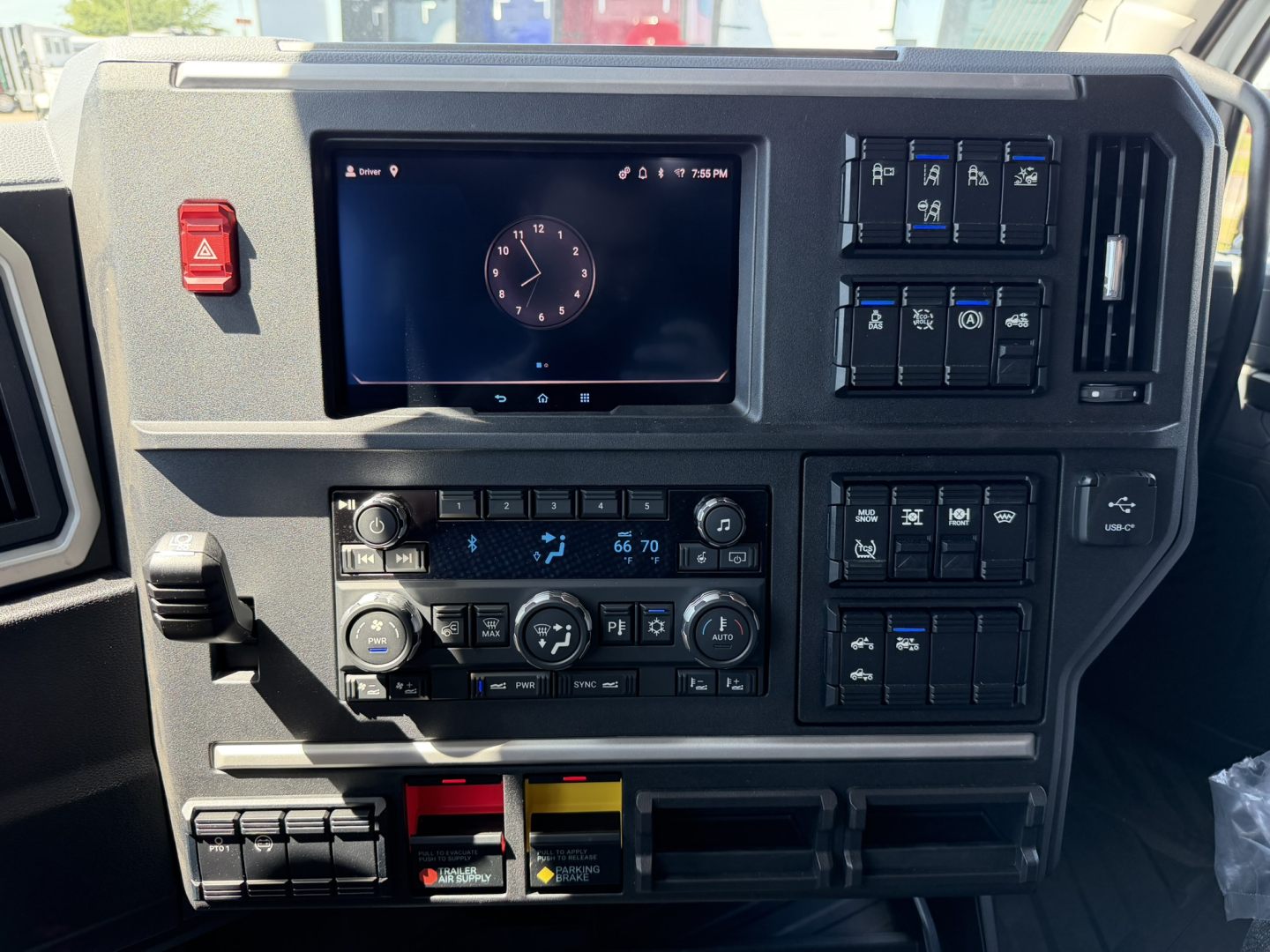 Dashboard of a 2027 Mack PR64T76H truck showing center touchscreen display, climate controls, and various switches.