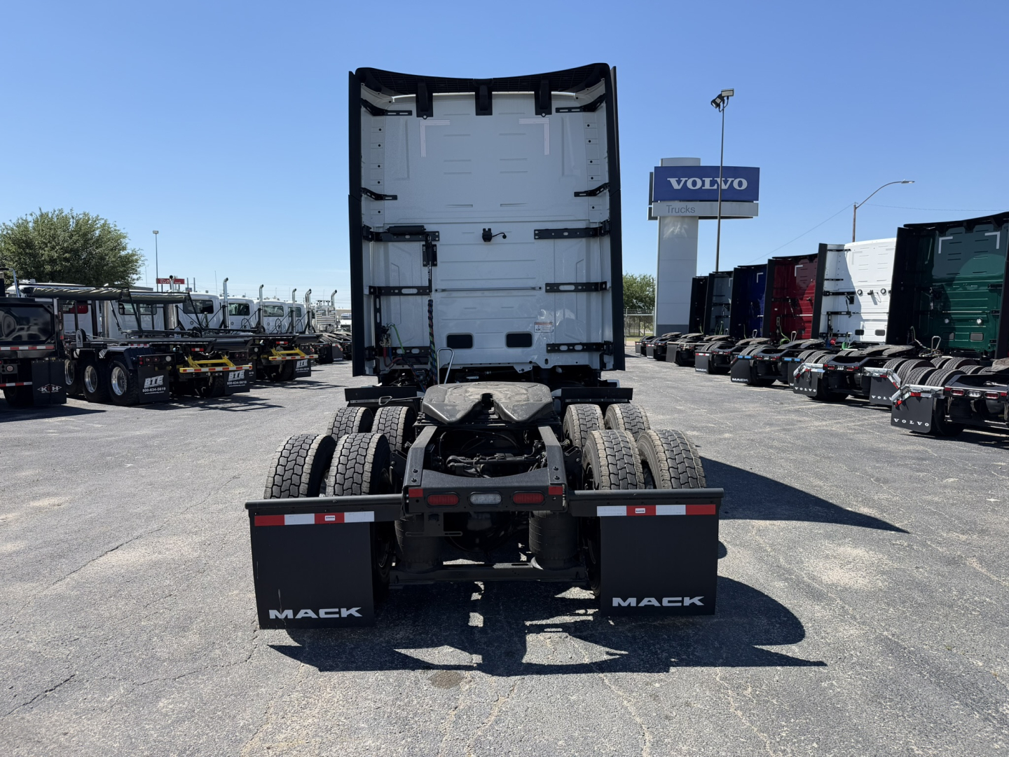 Mack PR64T76H tractor cab rear view showing chassis and dual rear axles with mud flaps and trailer hitch.