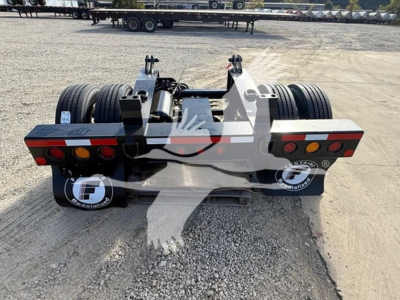 Ford Fontaine flip axle trailer rear view showing dual tandem axles and rear lighting with reflectors and branding on mud flaps