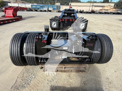 Fontaine flip axle trailer coupling with dual drivetrain and label plates on sides; rear view showing hydraulic components and tires.