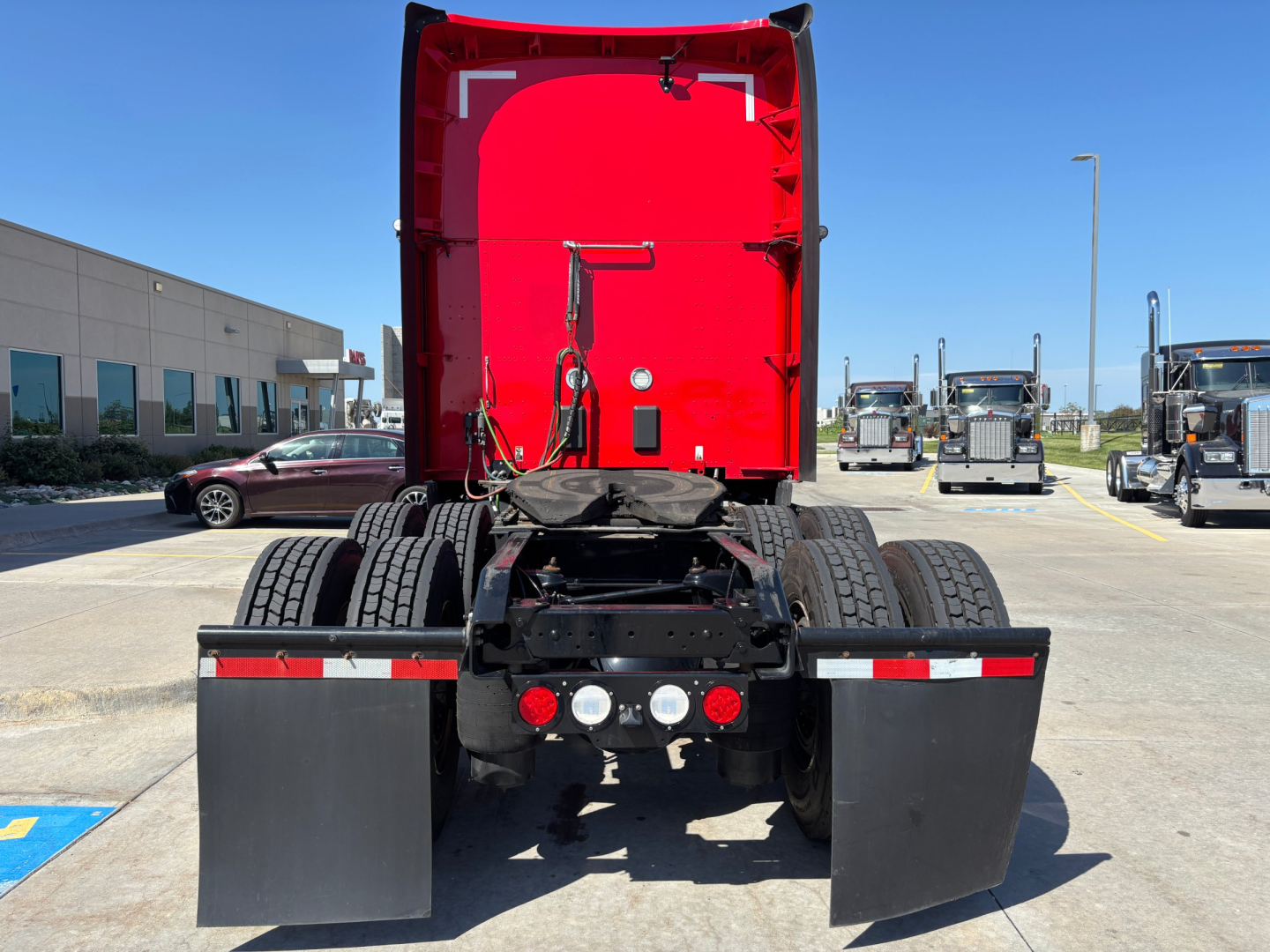 Kenworth T680 rear view showing fifth wheel, dual rear axles, and mud flaps.