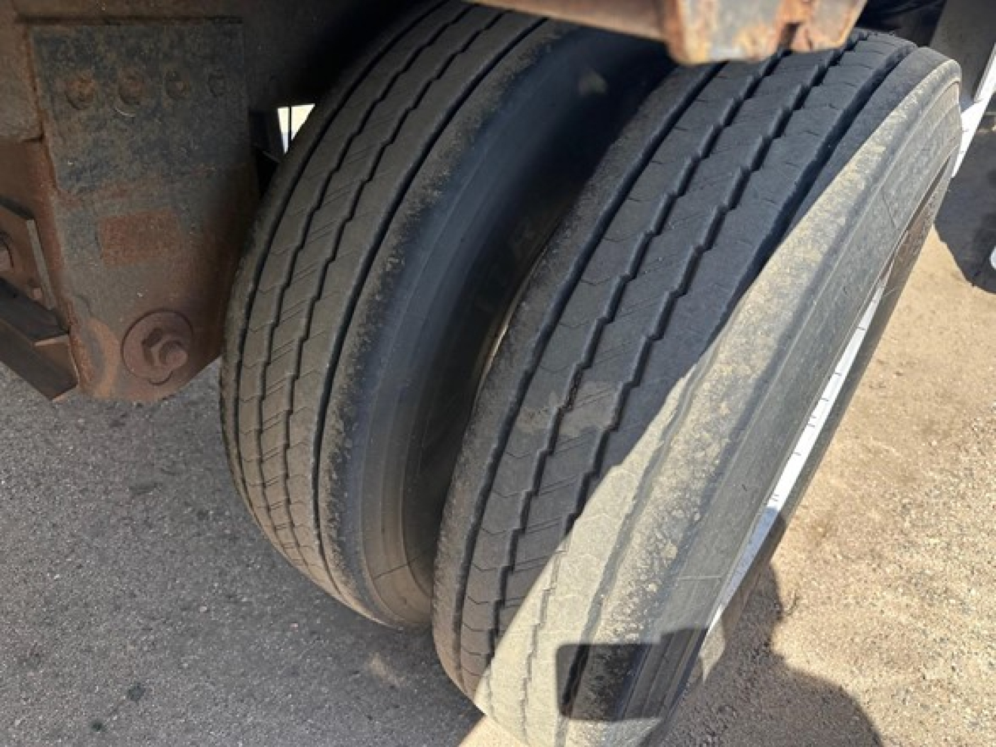 Trailer axle and dual rear tires showing tread and sidewall detail on a used 2010 Timpte Super Hopper trailer.