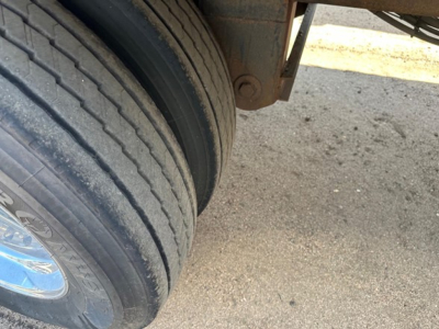 Timpte Super Hopper trailer wheel area with dual tires visible and part of the landing gear in view.