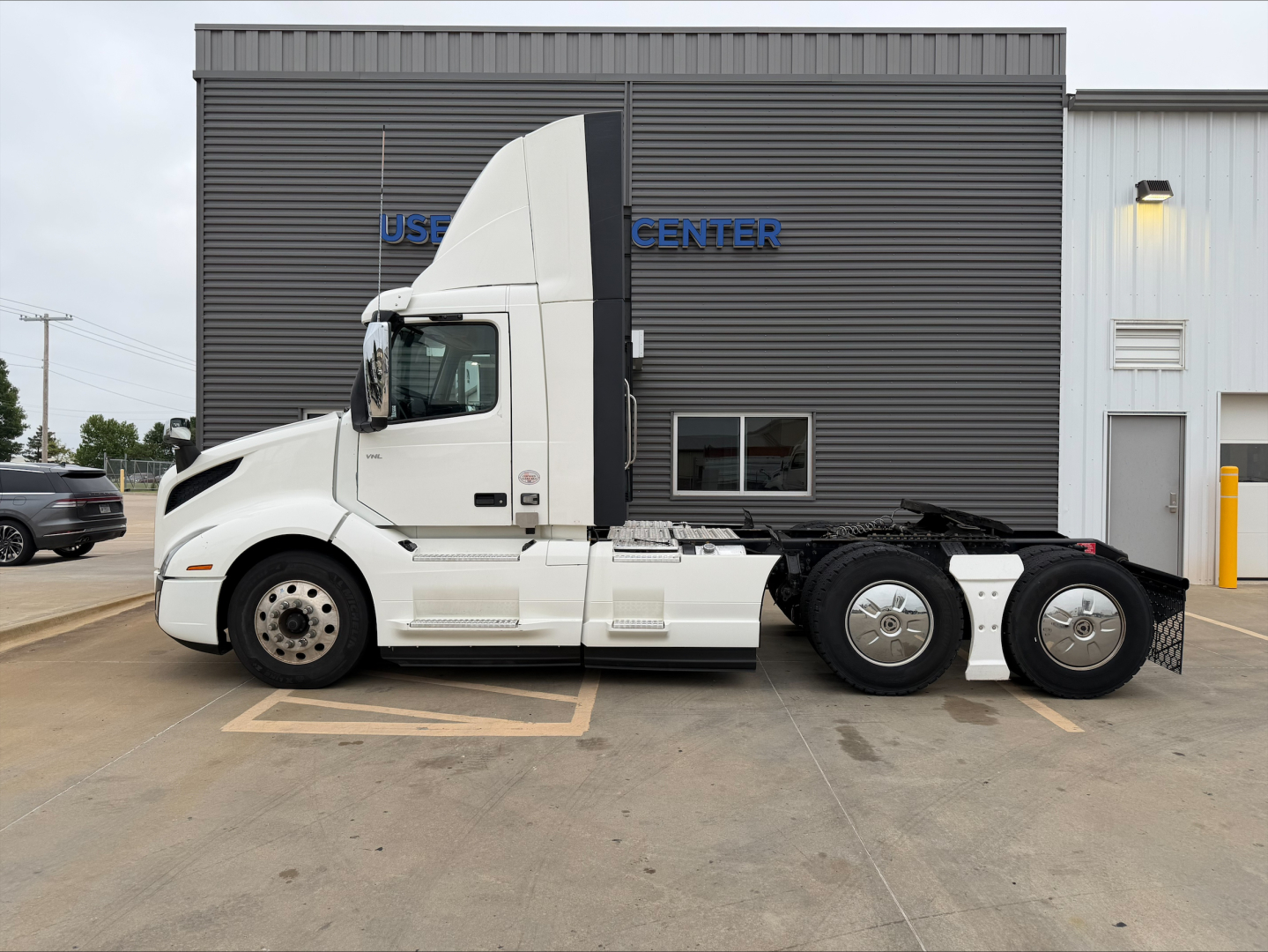 2019 Volvo VNL300 truck tractor side view showing sleeper cab and rear dual axles.