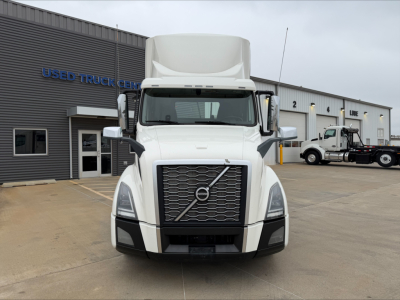 Front view of a white 2019 Volvo VNL300 daycab truck in a dealership lot with large grille and Volvo emblem visible.